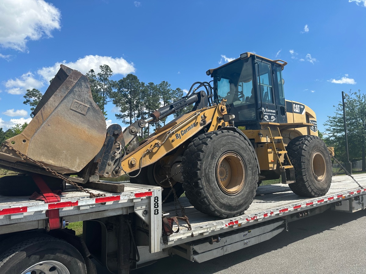 Construction equipment on a Covax open-deck trailer